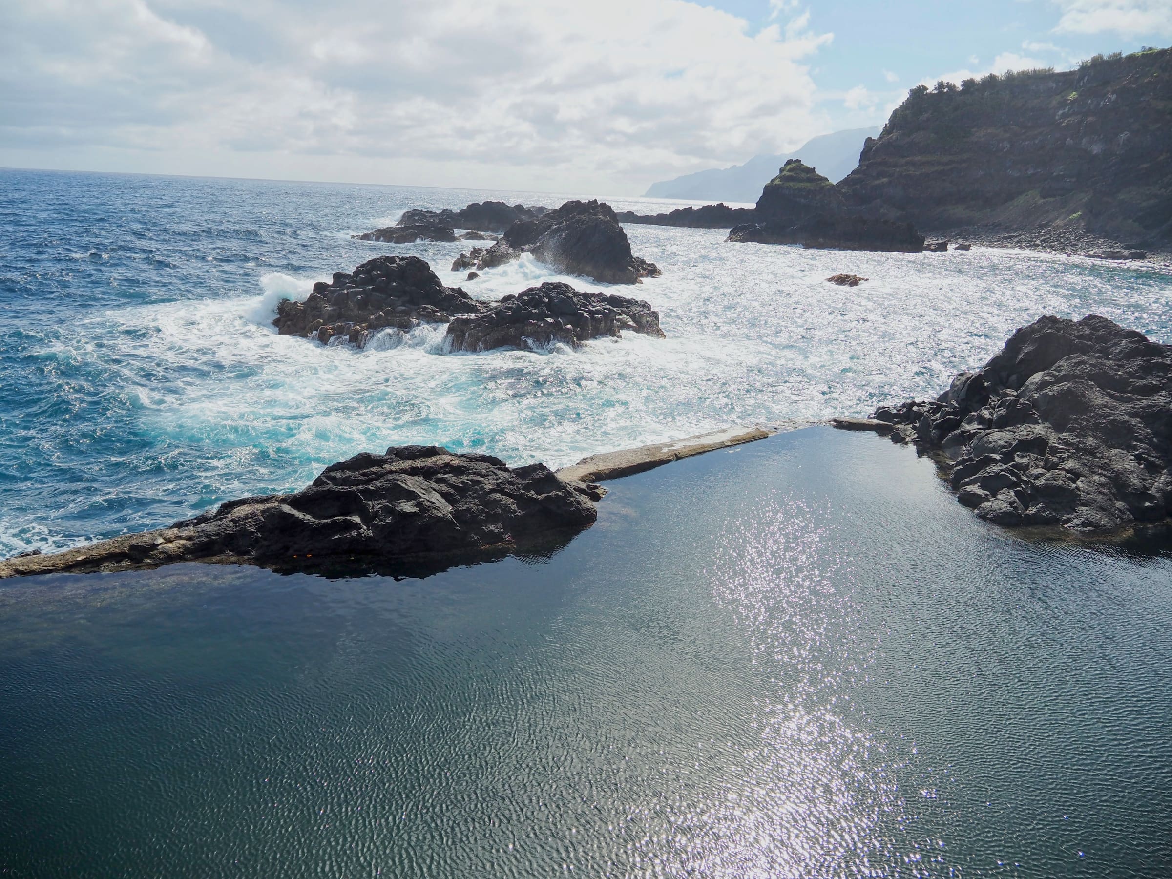 Turquoise volcanic natural swimming pools at Porto Moniz meeting the open Atlantic, Madeira.